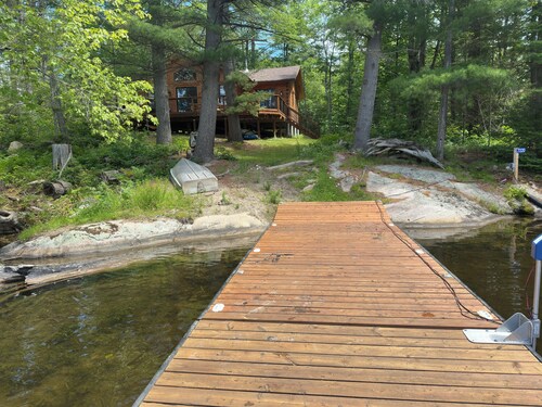Timber cottage with large deck overlooking the water. Boat access only, no road.