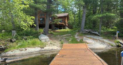 Timber cottage with large deck overlooking the water. Boat access only, no road.