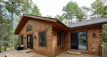 Timber cottage with large deck overlooking the water. Boat access only, no road.