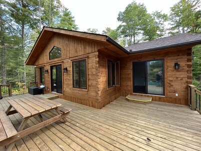 Timber cottage with large deck overlooking the water. Boat access only, no road.