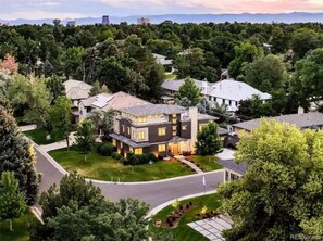 Stunning two-story home surrounded by lush greenery and a well-maintained front yard.