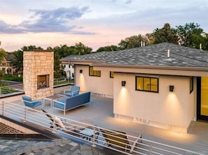 Enjoy a peaceful retreat with a balcony offering seating and a stone fireplace feature.