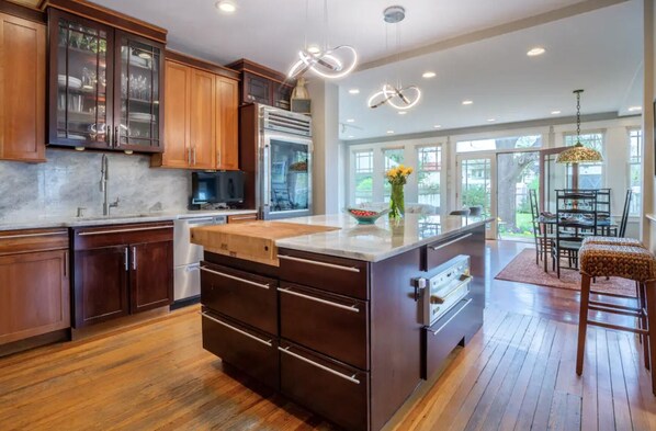 Enjoy cooking in this well-equipped kitchen with a large island, oven, and microwave.