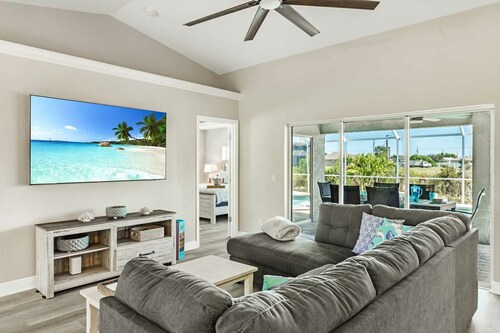 Tropical Gem! Sparkling Saltwater Pool • Peaceful Canal with Dock• Luxe Comfort
