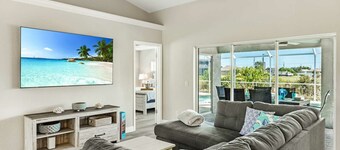 Tropical Gem! Sparkling Saltwater Pool • Peaceful Canal with Dock• Luxe Comfort