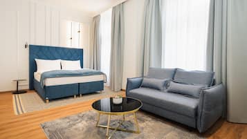 Deluxe Apartment | Living area | 55-inch Smart TV with digital channels