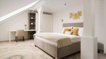 A bedroom with a bed, a desk, a chair, and a bookshelf.