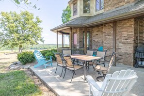 A patio with a table and chairs, a grill, and a view of the landscape. - A spacious finely-appointed luxury hideaway, nestled in the Ozark Mountains. (Lebanon)