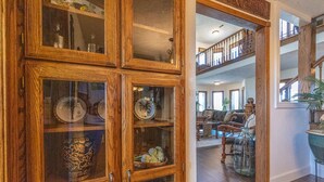 A wooden cabinet with glass doors displaying various decorative items. - A spacious finely-appointed luxury hideaway, nestled in the Ozark Mountains. (Lebanon)