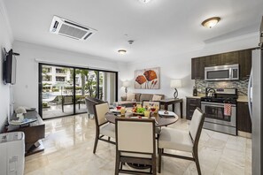 Deluxe Condo, 1 Queen Bed | Living area | 40-inch flat-screen TV with digital channels