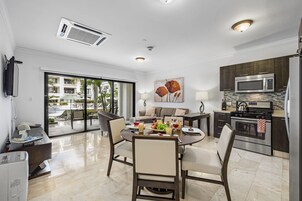 Deluxe Condo, 1 Queen Bed | Living area | 40-inch flat-screen TV with digital channels