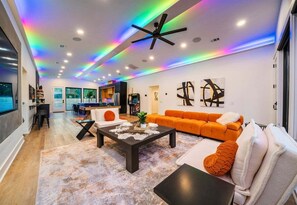 A modern living room with a sofa, coffee table, and artwork on the walls.