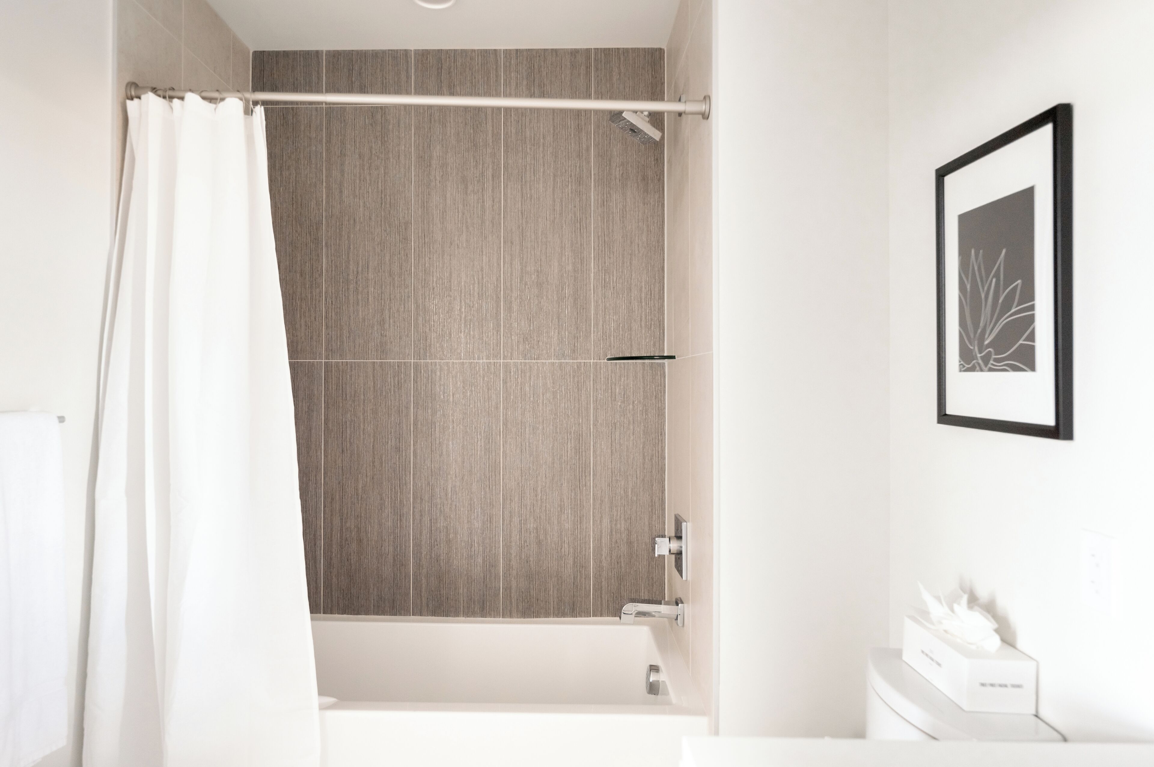 A modern bathroom with a shower, a bathtub, and a toilet.