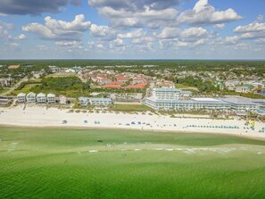 A coastal town with a beach, several beachfront hotels, and a mix of residential and commercial buildings. - Horizon South 23A | 5 Pools, Hot Tub, Clubhouse, Gym, Sports Courts, Grills, Parking Onsite (Panama City Beach)