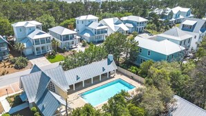 A residential area with multiple houses, a swimming pool, and surrounding greenery. - Vitamin Sea by Stay on 30a (Inlet Beach)