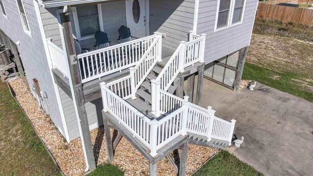A two-story house with a balcony and a small deck. - Beachside Breeze! 5 BR 3 BA beach paradise!  (Nags Head)