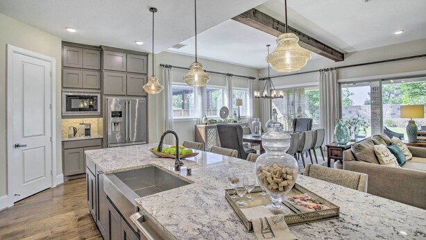 A modern kitchen with granite countertops, stainless steel appliances, and pendant lighting. - Family-friendly Brookshire Home w/ Game Room! (Katy)