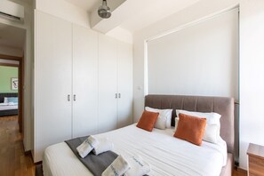 A bedroom with a bed, pillows, a blanket, a wardrobe, and a ceiling light. - ★ Jay`s Penthouse 2-BR Apt W/ Terrace in Larnaca (Cyprus - Larnaca)