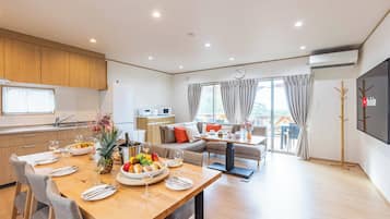 Family Villa | Living area | 75-inch flat-screen TV with digital channels