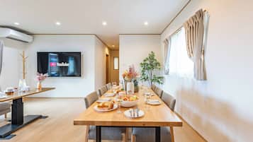 Family Villa | Living area | 75-inch flat-screen TV with digital channels