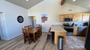 Una cocina moderna con armarios de madera, una estufa de acero inoxidable y un microondas.