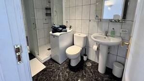 A modern bathroom with a shower, toilet, and sink. - Harbour Lights Puerto del Carmen (Puerto del Carmen)