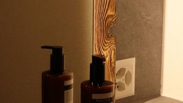 Two bottles of hand and body lotion on a shelf.