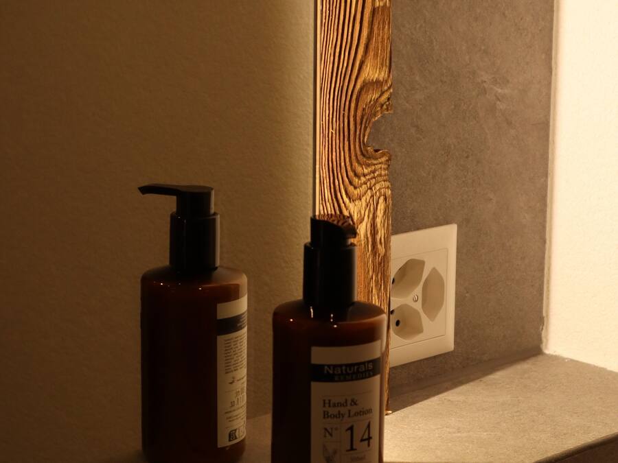 Two bottles of hand and body lotion on a shelf.