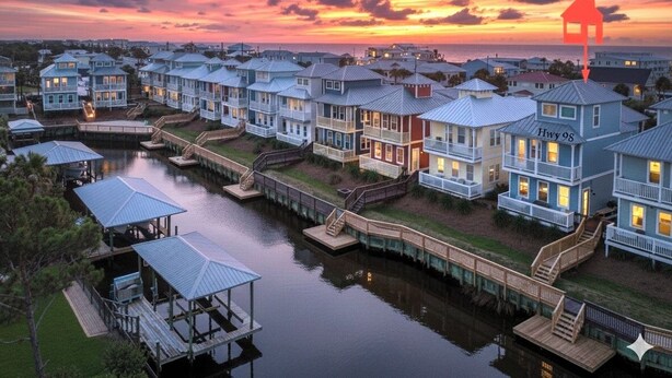 A waterfront residential area with multiple two-story houses connected by walkways over water. - Beach Haven, Game Room, Arcades (Mexico Beach)