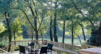 Cozy riverfront cabin with great outdoor space including a hot tub!