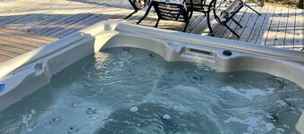 Cozy riverfront cabin with great outdoor space including a hot tub!