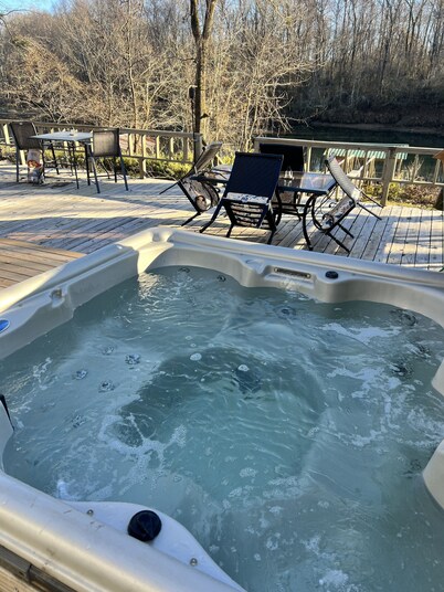 Cozy riverfront cabin with great outdoor space including a hot tub!