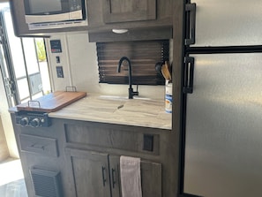 Enjoy cooking in this kitchenette with a stovetop, microwave, and refrigerator.