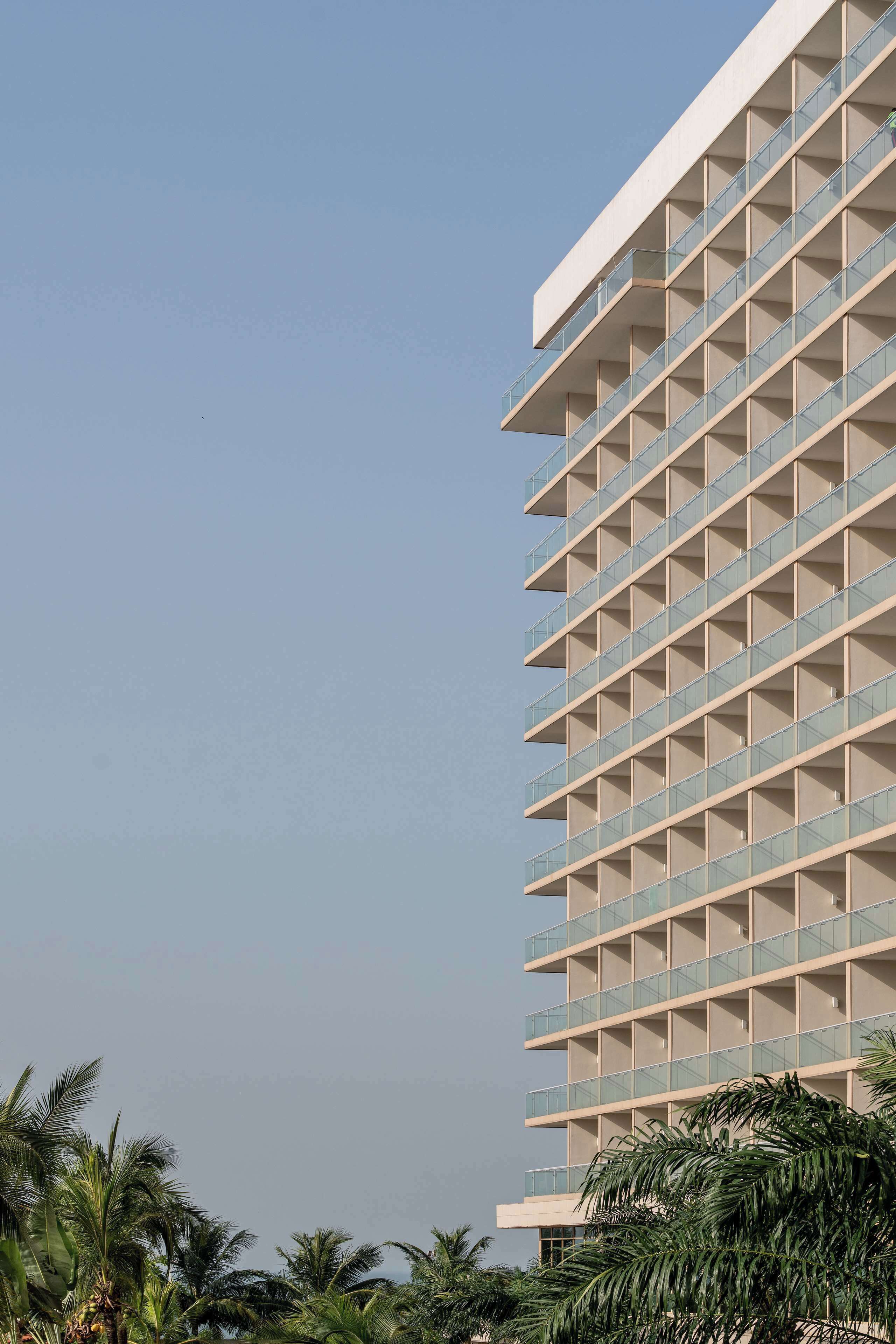 A high-rise building with multiple balconies, likely a hotel or residential building.
