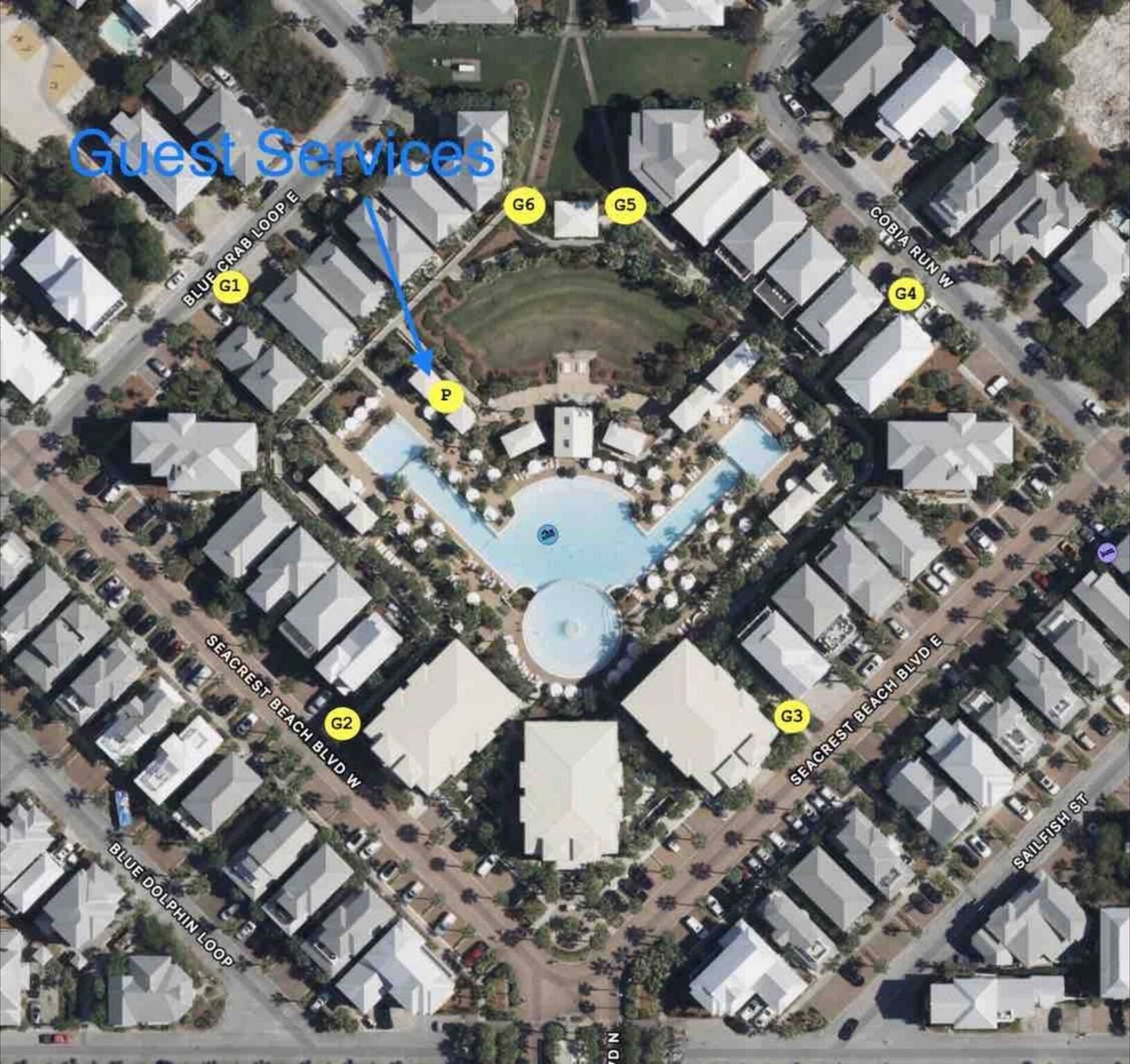 An aerial view of a hotel with a central pool, guest services, and multiple guest rooms.
