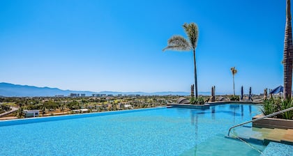 Mountain-view apartment near beach with balcony, rooftop pool, gym, & Ping-Pong