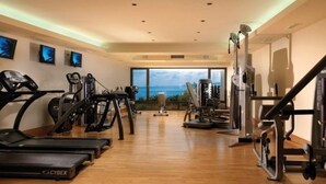 A gym with treadmills, stationary bikes, and weight machines.