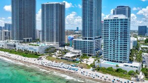 A high-rise hotel with multiple floors, a beachside location, and a pool area. - HYDE 3BR OceanFront Suite w SunriseTo Sunset Views (Hollywood)