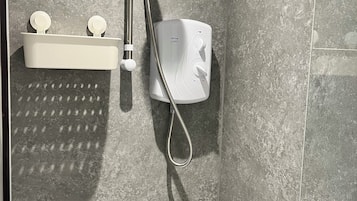 Shower, hair dryer, towels, toilet paper