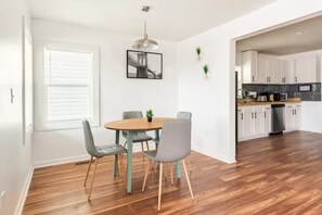 A modern kitchen with white cabinets, a wooden countertop, and a built-in oven. - A Place to Esape too (Birmingham)