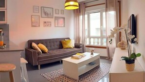 A modern living room with a sofa, coffee table, and decorative items.