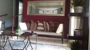 A living room with two sofas, a coffee table, and a staircase. - #4 Casa Galarza (Cabo Rojo)