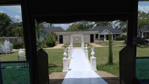 A covered outdoor area with a white pathway leading to a building. - Sega Lodge (Sega)