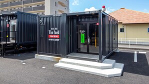 A compact hotel structure with a sign indicating it is part of the R9 Hotels Group. - HOTEL R9 The Yard Kirishimakokubu (Kirishima)