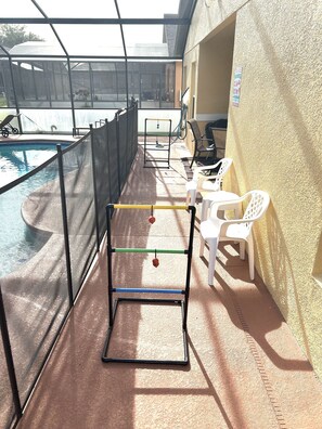 Relax by the pool surrounded by a glass enclosure and comfortable seating.