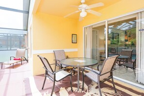 Relax on the balcony with a glass table and four chairs, surrounded by a patio area with additional seating.
