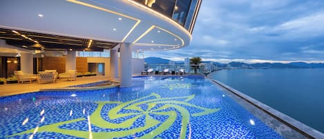 Outdoor pool, open 6:00 AM to 7:00 PM, pool umbrellas, pool loungers