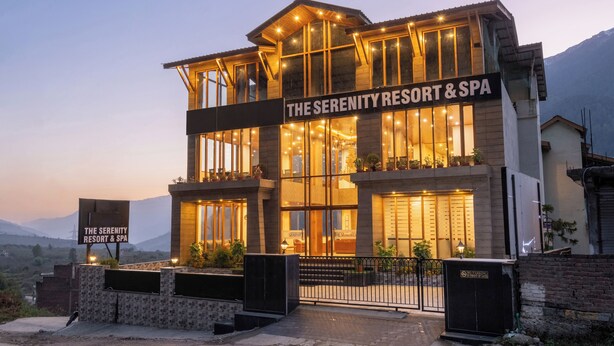 A two-story building with a sign reading "The Serenity Resort & Spa". - DLS Serenity Resort And Spa (Manali)