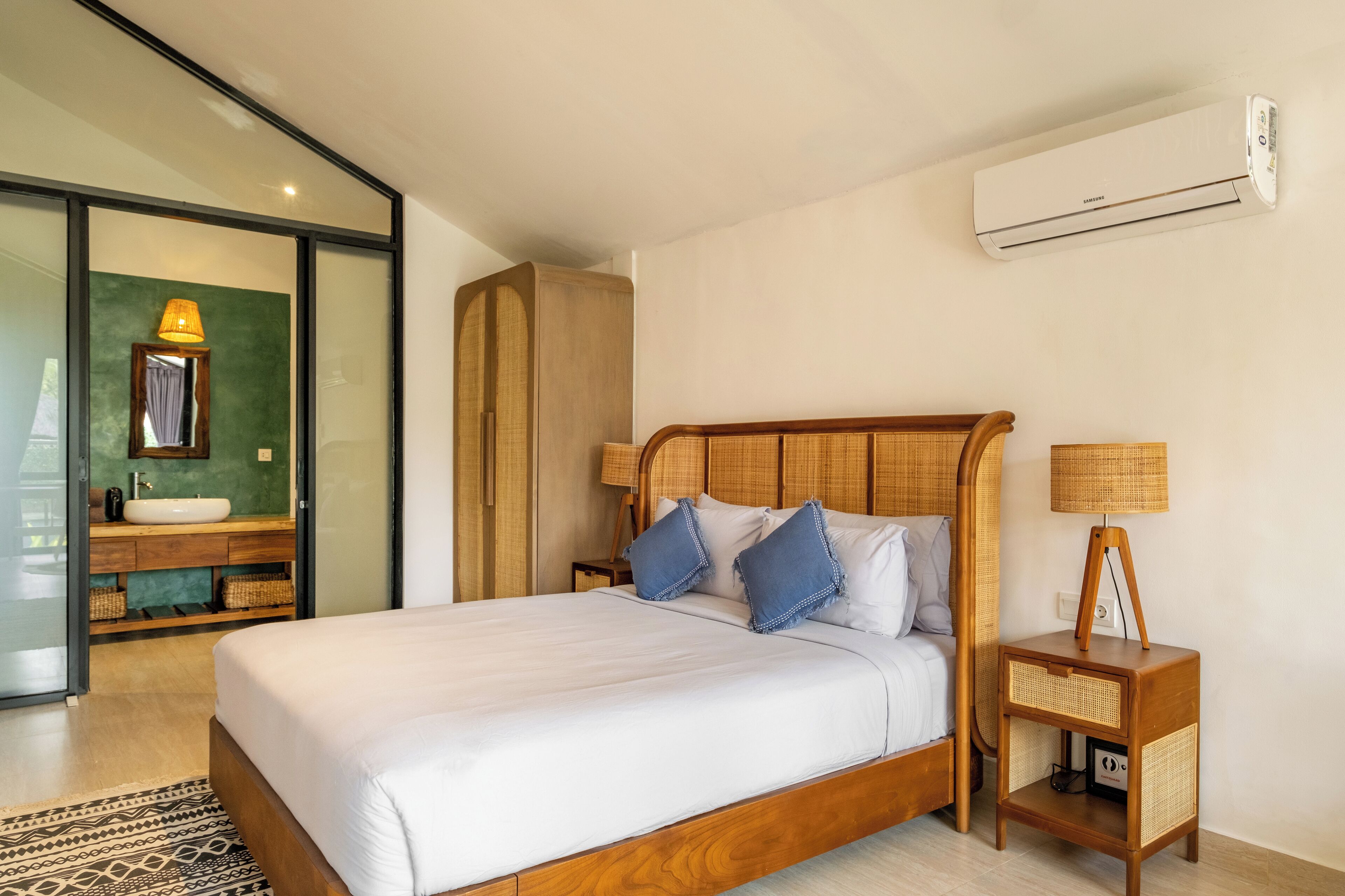 A modern bedroom with a wooden bed, a bedside table with a lamp, a built-in bench, and a large window.