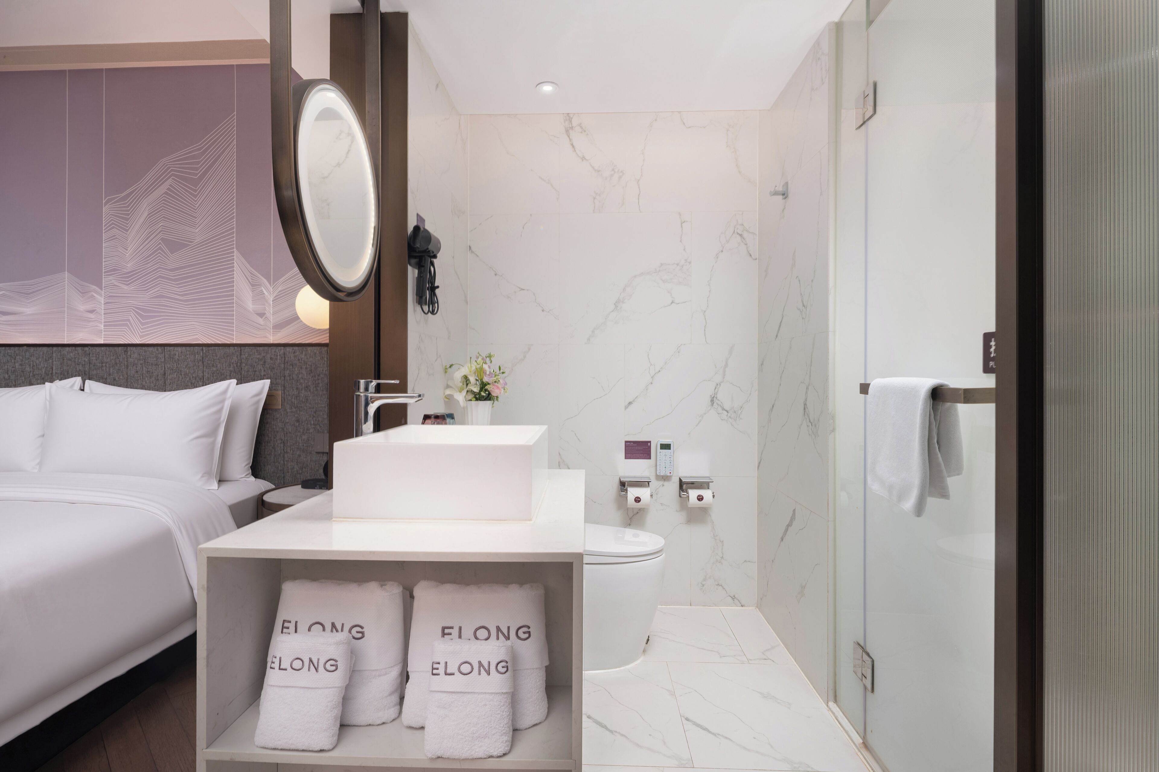 A modern bathroom with a large mirror, a toilet, and a shower area.